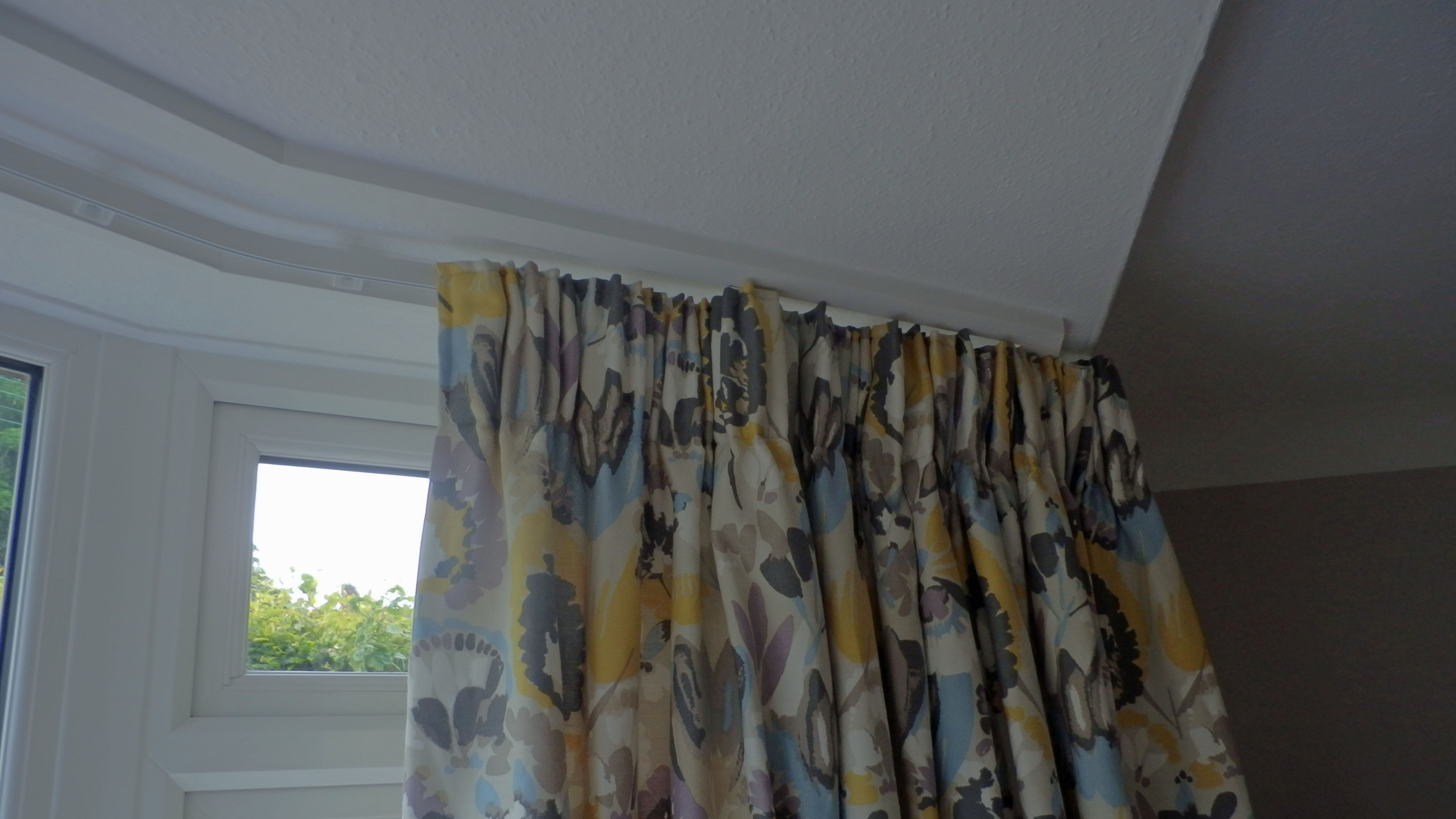 Curtains on a bay window track